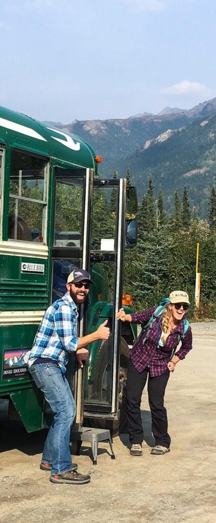 Jake and Lindsey pose next to DEC's bus as they get ready to embark on a hiking adventure with a learning vacation group.